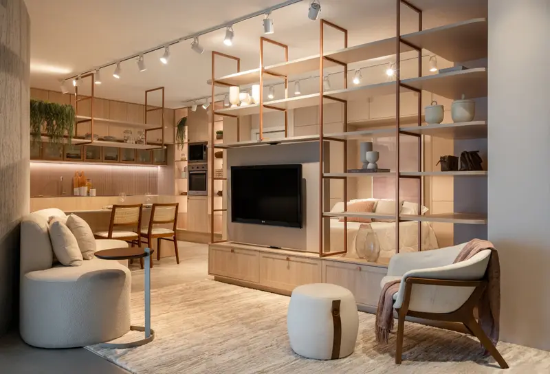 Living com painel de TV giratório e estante em estrutura cobre